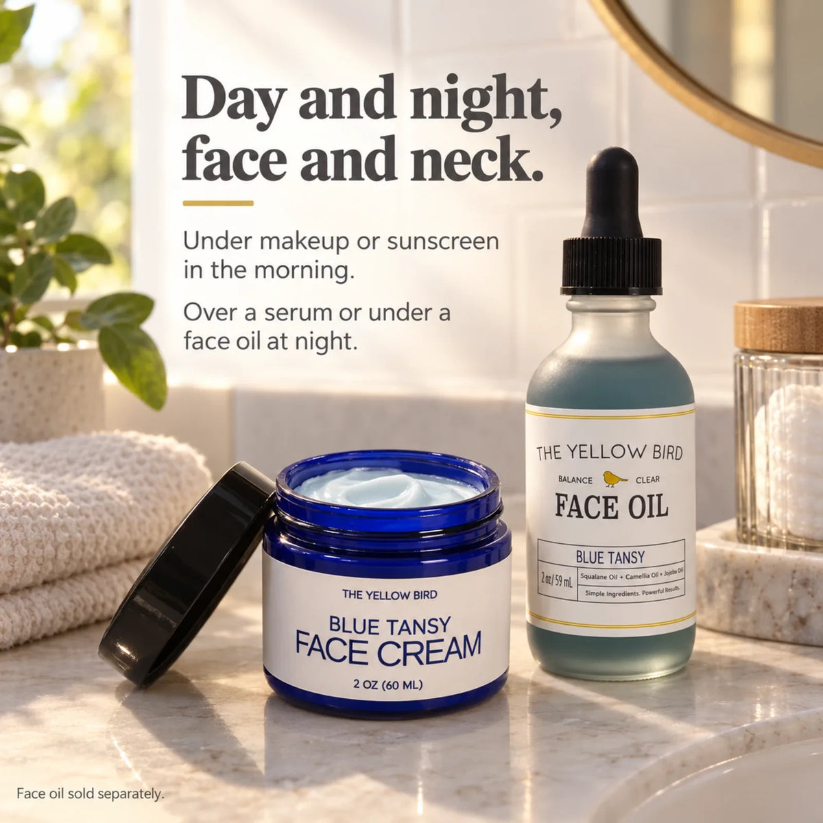 Open Blue Tansy Face Cream jar next to Blue Tansy Face Oil on a bathroom counter, for day and night use on face and neck