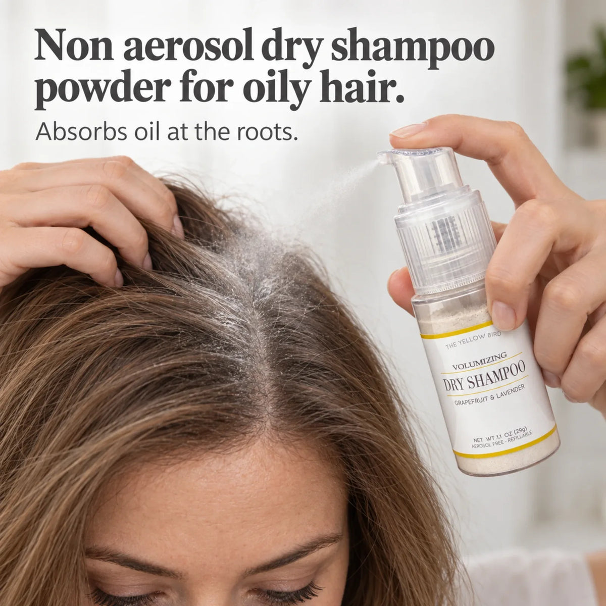 Woman applying Grapefruit Lavender non-aerosol dry shampoo powder to oily roots with the refillable pump bottle